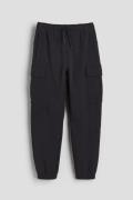 H&M DryMove™ Cargo-Joggpants aus Baumwolle Schwarz, Jogginghose in Grö...